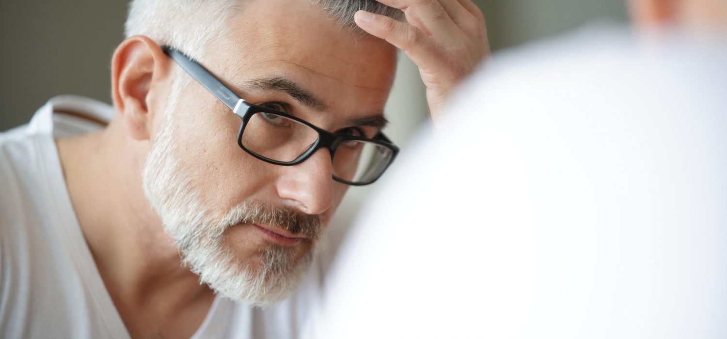 Portrait of man concerned by hair loss